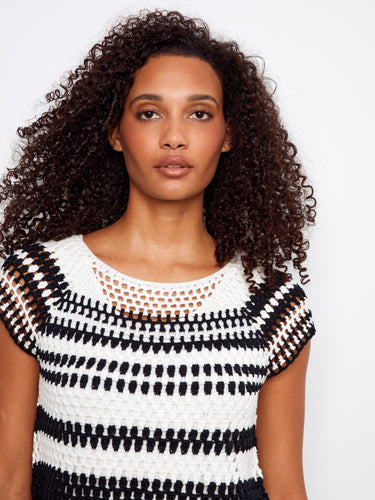 The top features raglan cap sleeves, adding a touch of elegance to the black and white striped design by Charlie B.