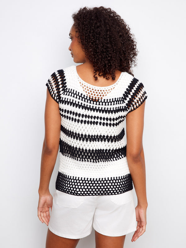 Elegant crochet pattern enhances the classic black & white stripes in this fashionable piece by Charlie B.