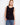 This sleeveless top features a classic crew neckline, perfect for layering or wearing alone. Designed by Charlie B.