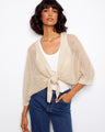 Beige crochet shrug with elbow dolman sleeves and adjustable tie-front design, perfect for layering by Charlie B.