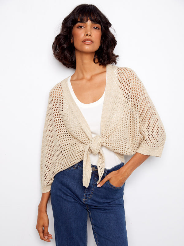 Beige crochet shrug with elbow dolman sleeves and adjustable tie-front design, perfect for layering by Charlie B.