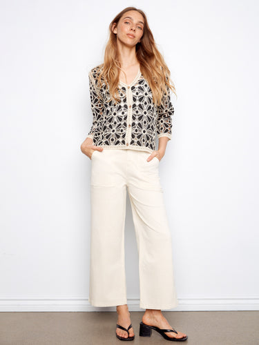 Chic button-front closure adds a classic touch to this beautifully detailed crochet top, perfect for any occasion by Charlie B.