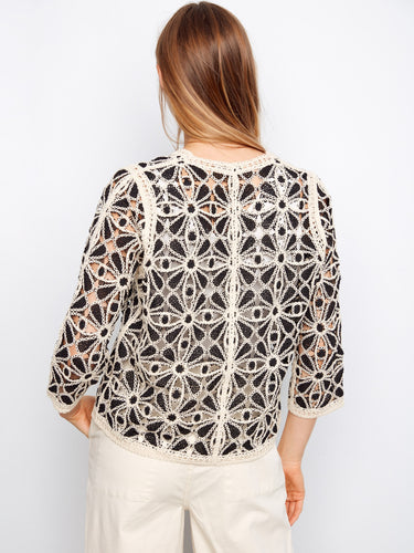 The back view reveals the stunning detail of the floral motifs in this charming button-front crochet blouse by Charlie B.