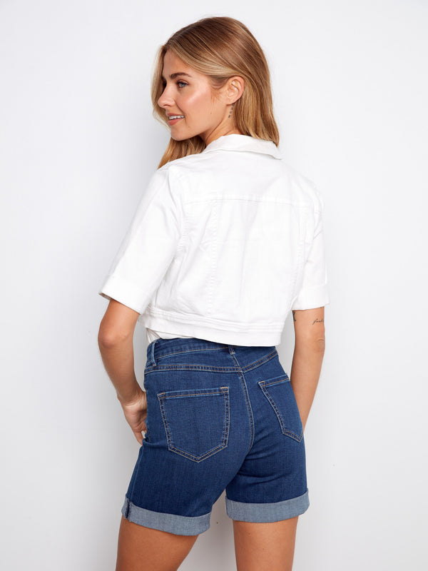 Elegant white jacket showcasing front chest pockets, perfectly matched with denim shorts for a casual vibe by Charlie B.