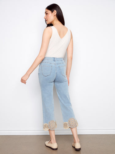 Light blue jeans with flared leg design, enhancing a trendy silhouette effortlessly by Charlie B.