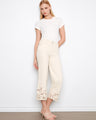 Natural jeans with a flared fit and floral lace hem, crafted in stretch twill for comfort and style by Charlie B.