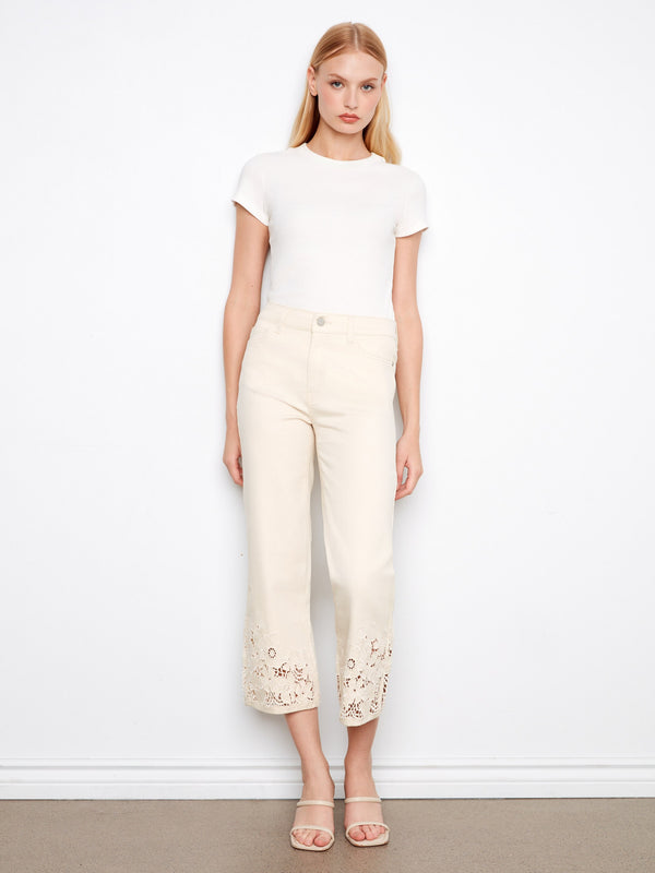 White cropped jeans featuring a regular rise and classic five-pocket design, accented with delicate lace by Charlie B.