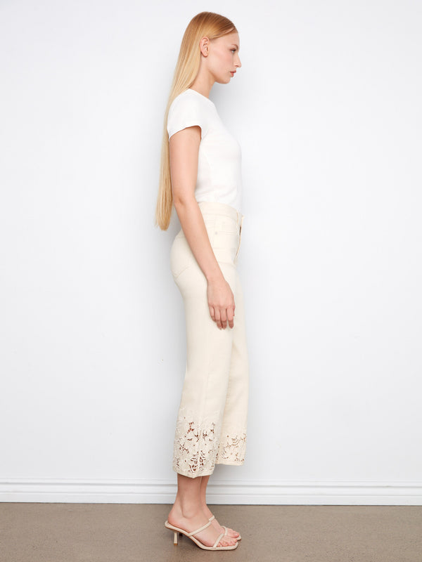 Stylish natural jeans with a classic five-pocket design and intricate lace detailing on the hem by Charlie B.
