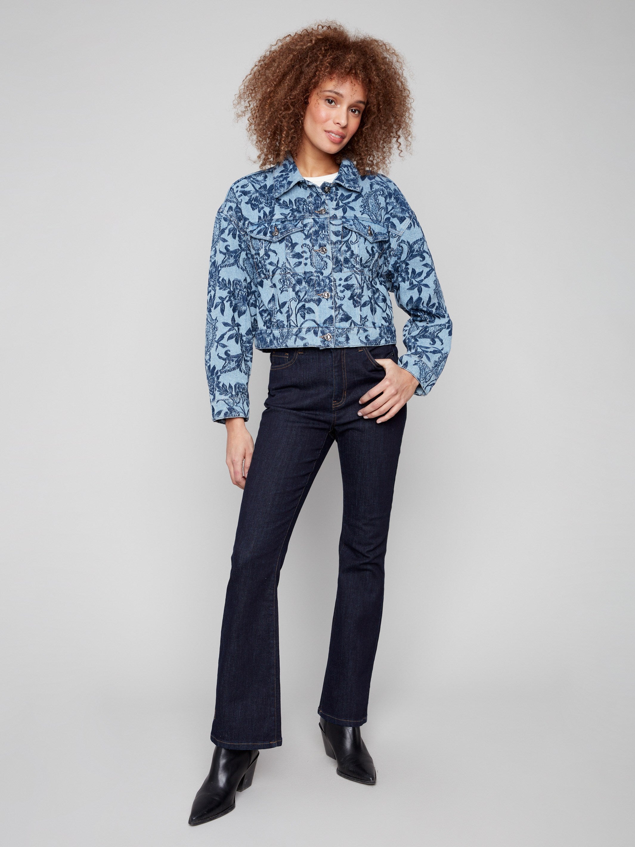 This cropped denim jacket showcases two chest flap pockets, enhancing its functional style by Charlie B.