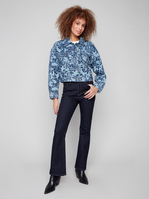 This cropped denim jacket showcases two chest flap pockets, enhancing its functional style by Charlie B.
