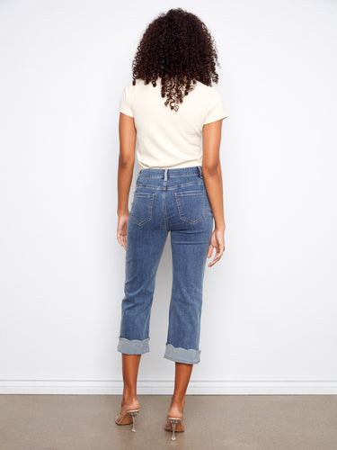 Denim pants in medium blue offering a cropped length and fashionable scallop cuff detail for versatile styling by Charlie B.