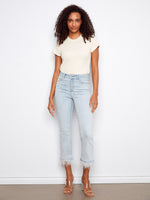 These jeans feature a flared leg design, offering a stylish silhouette with their unique removable feather hem by Charlie B.