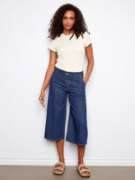 The denim pants feature a stylish wide leg fit, offering both comfort and flair for any casual outing. By Charlie B.