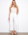 White cropped flare twill pants with regular rise and back pockets, modeled stylishly by Charlie B.