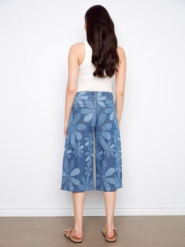 Stretch denim palazzo pants in a floral print, offering both style and comfort with slash pockets by Charlie B.