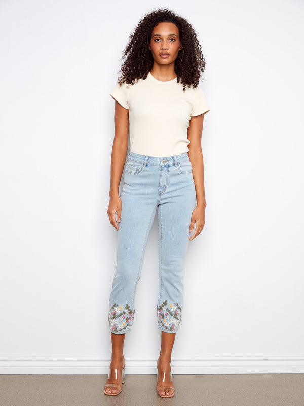 Stretch denim jeans in a slim fit, highlighted by intricate floral details on the cropped legs. By Charlie B.