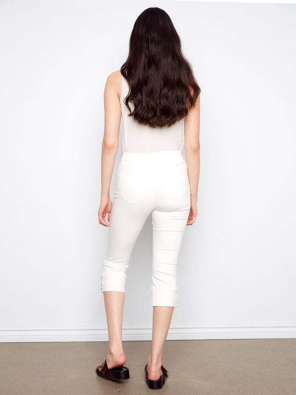 Embrace the slim fit of these white cropped jeans, complete with chic snap button cuffs by Charlie B.