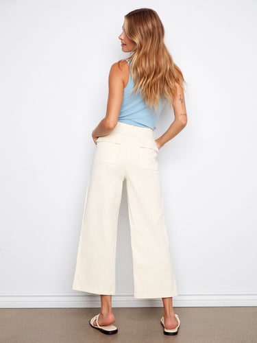 Stretch twill fabric pants paired with a light blue top and casual sandals by Charlie B.