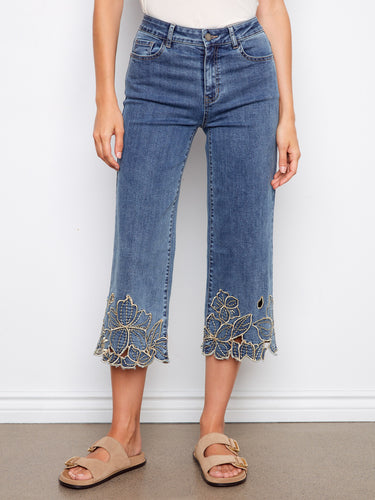These stylish jeans showcase a five-pocket design with beautiful flower embroidery at the hem, adding a unique touch. By Charlie B.