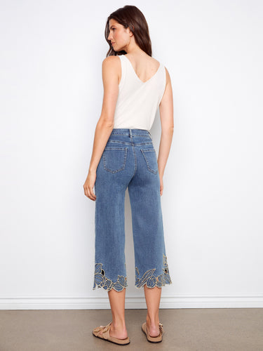 Embrace a casual look with these cropped denim pants that feature an elegant flower embroidery at the hemline. By Charlie B.