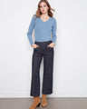 Denim pants featuring a wide leg design, paired with a blue top and brown boots. Crafted for comfort and style by Charlie B.