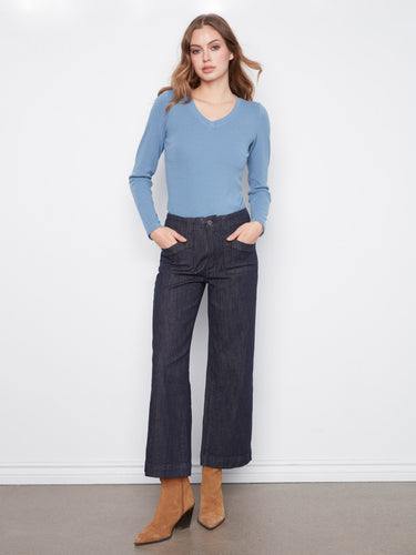 Denim pants featuring a wide leg design, paired with a blue top and brown boots. Crafted for comfort and style by Charlie B.