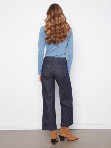 A stylish ensemble featuring wide leg denim pants with patch pockets, matched with a blue top. Beautifully designed by Charlie B.