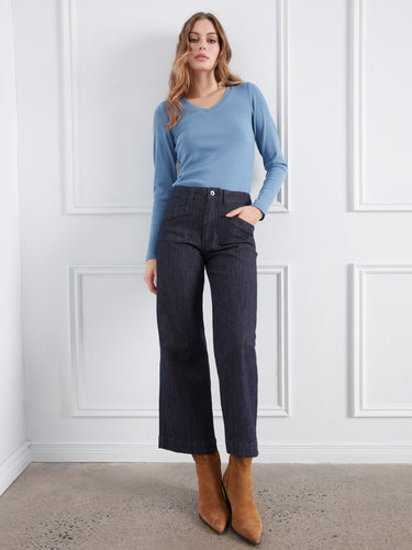 Wide leg jeans in stretch fabric paired seamlessly with classic brown boots and a soft blue sweater. Designed uniquely by Charlie B.