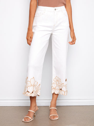 Cropped white jeans with five-pocket design and intricate flower embroidery, crafted from stretch denim by Charlie B.