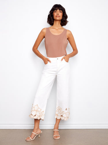 Floral embroidered hem on white cropped jeans, designed in a comfortable wide fit with five pockets by Charlie B.