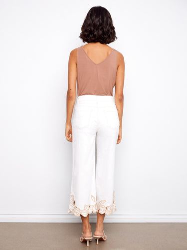 Cropped white jeans featuring elegant flower embroidery at the hem, made from stretch denim for comfort by Charlie B.