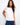 White cotton top featuring a crew neckline for a classic look. Enhanced with embroidery at the shoulder by Charlie B.
