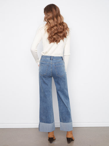 The jeans showcase a classic five-pocket style with a modern twist of cuffed hems for added flair by Charlie B.