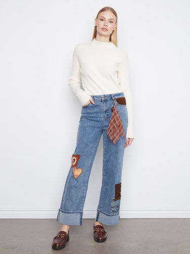 These jeans feature a stylish straight leg design with decorative patches and studs for a unique look by Charlie B.