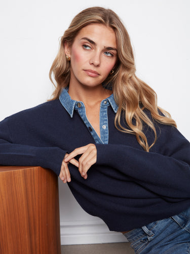 This navy sweater features ribbed cuffs and hem, adding a touch of sophistication to its casual appeal. A timeless piece by Charlie B.