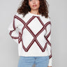 White sweater with cabernet diamond pattern and a cozy crew neck, highlighting the drop shoulder design by Charlie B.