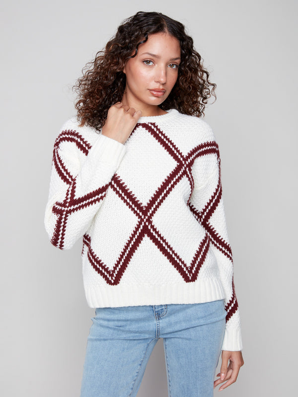 Chic white sweater featuring a cabernet diamond intarsia knit with long sleeves and crew neck by Charlie B.