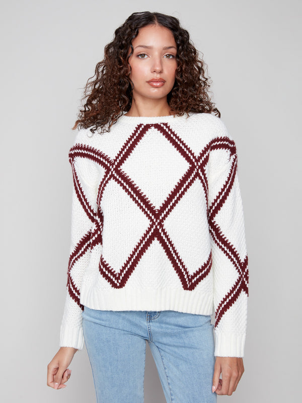White sweater adorned with a cabernet diamond design, complete with comfortable drop shoulders by Charlie B.