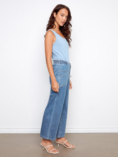 Stylish patch pockets enhance the design of these regular rise denim pants. By Charlie B.