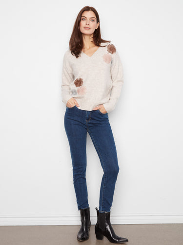 This sweater offers a relaxed fit with long sleeves, perfect for layering during cooler seasons. By Charlie B.