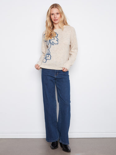 The ribbed cuffs and hem of this sweater add subtle detail, enhancing its casual elegance by Charlie B.