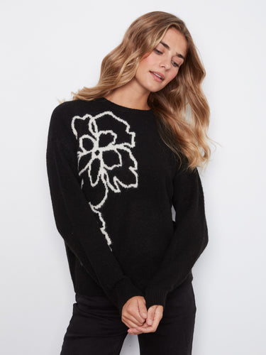 Black sweater featuring a crew neckline and floral design, paired with dark pants, perfect for a casual outing by Charlie B.