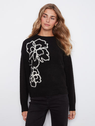 Chic black top highlighted by a bold white flower motif, offering a blend of elegance and modern fashion by Charlie B.