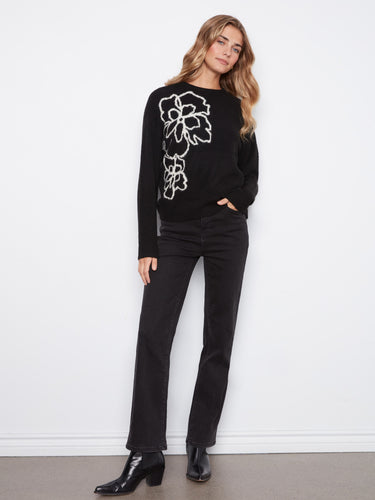 Classic black sweater adorned with intricate flower design elements crafted by Charlie B.