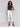 White twill pants in bootcut style with stretch fabric and tulip hem detailing by Charlie B.