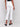 White bootcut pants showcasing elegant embroidered details on stretch twill fabric by Charlie B.