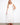 Natural sleeveless dress featuring an elegant V-neckline and flowing maxi length by Charlie B.