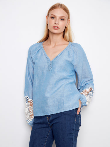 Stylish blouse showcasing balloon sleeves with intricate openwork lace details, perfect for an elegant appearance. By Charlie B.