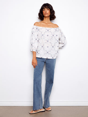 Stylish top highlighting beautiful floral embroidery and a flattering off-the-shoulder style. Made from soft, pure cotton by Charlie B.
