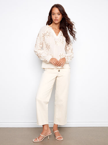 Ecru long-sleeve top showcasing beautiful raglan sleeves and delicate floral patterns for elegance by Charlie B.